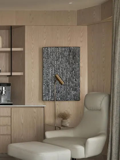 Every tranquil bedroom deserves a coffee station. We created this dedicated coffee bar in the master bedroom, complete with a comfortable recliner, making it the perfect corner for a quiet morning ritual.