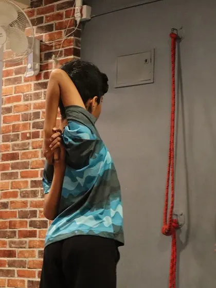Students work on Gomukhasana (Cow Face Pose) arms, a deep shoulder stretch that we often practice to prepare for more complex poses.