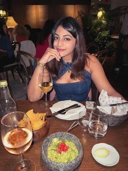 A dinner setting in Dubai. The denim outfit is versatile enough for a chic dinner, paired with simple accessories.