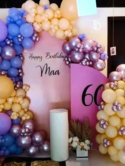 A lovely birthday setup for 'Maa's' 60th, using a soft and unique color palette of pastel yellow, purple, and pink.