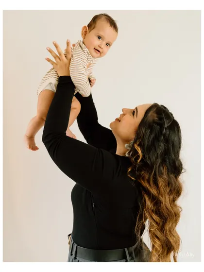 Lifting her baby high, this mother's face is full of adoration. These are the moments of pure joy I love to freeze in time.