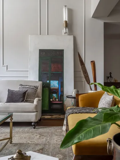A detail of the formal living area, showing the mix of textures and art. The English roll-arm couch is paired with a client's personal art piece, creating a space that feels both designed and deeply personal.