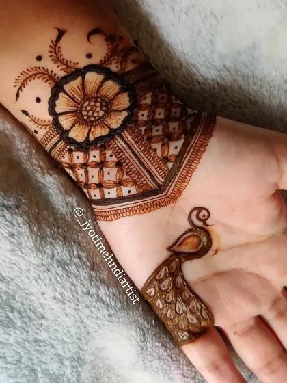 A unique design where a peacock motif on the thumb connects to a floral cuff on the wrist, creating a beautiful and cohesive piece.