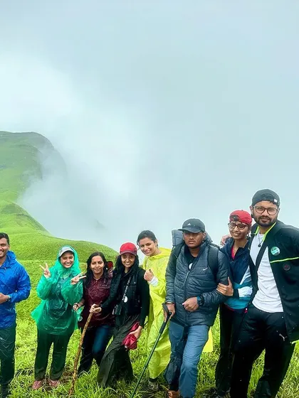 A group of friends on a misty mountain top. The camaraderie and shared experience are what make these treks special.