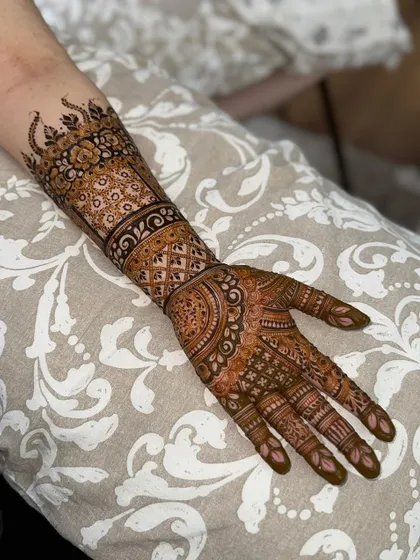 The complete front-hand design, showcasing the balance between the cuff, palm work, and finger details.