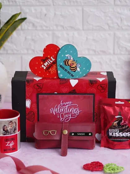 This "Valentine Delight Hamper" includes a personalized ceramic mug with your photos, a custom eyewear case, two heart-shaped tea coasters, and Hershey's Kisses chocolate.