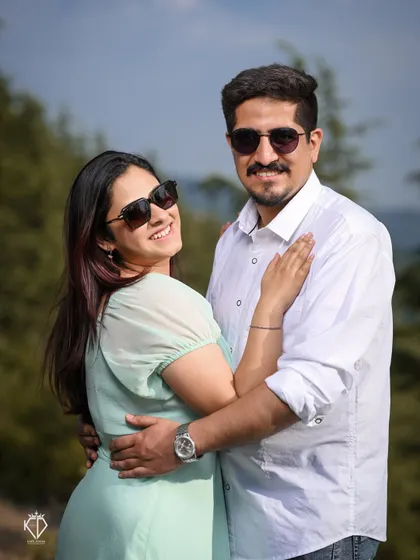 A fun and relaxed portrait of the couple in sunglasses, smiling and enjoying the bright sunny day in the hills.