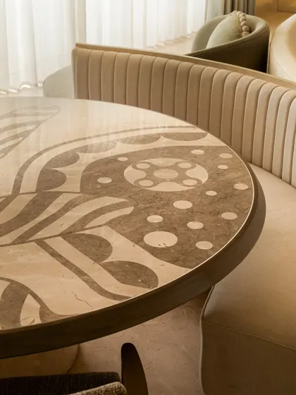 Another angle of the beautifully crafted dining table, showcasing the seamless integration of different marbles to create a stunning, graphic pattern.