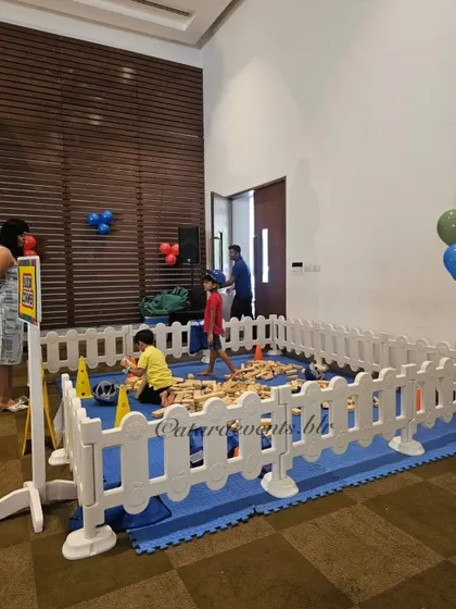 A dedicated play pen with soft flooring and large building blocks provides a safe and fun area for younger children to play.