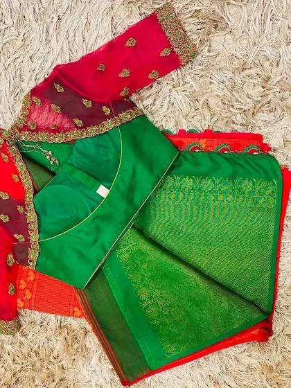 The back of the green and pink blouse, showing the sheer net panel with delicate embroidery.