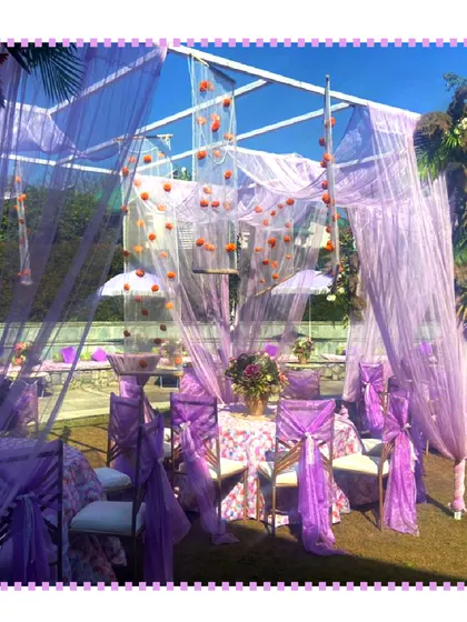 A beautiful wedding setup in Jim Corbett, with purple drapes creating an elegant and dreamy atmosphere against the green landscape.