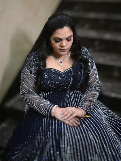 A quiet, contemplative moment showing the details of her eye makeup. The dark, smokey look adds a touch of drama and elegance to her overall appearance.