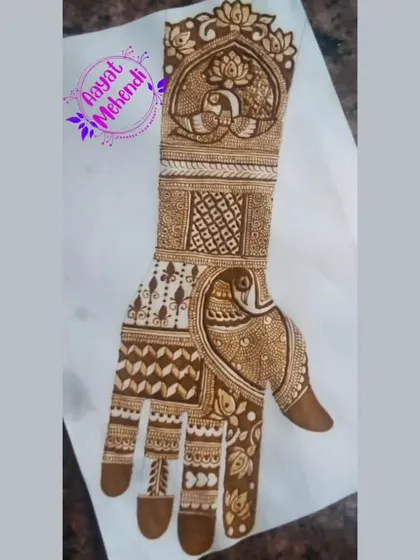 A full-hand design featuring peacock motifs, sketched on paper. This is a great way to plan out a complex bridal design.