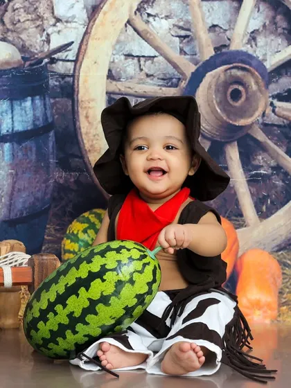 A happy cowboy and his watermelon. This sweet and funny photo captures a moment of pure, country-style joy.