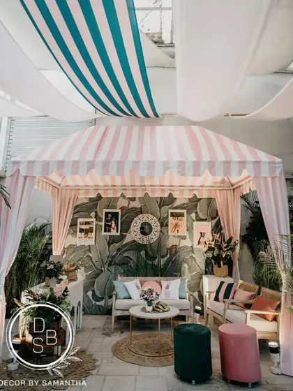 A wider shot of the cabana, showing how the ceiling drapes and lighting work together to create an intimate and stylish atmosphere for the post-wedding brunch.
