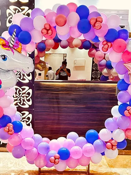 A unicorn-themed balloon ring, perfect for a photo booth or backdrop at a kid's birthday party at home.