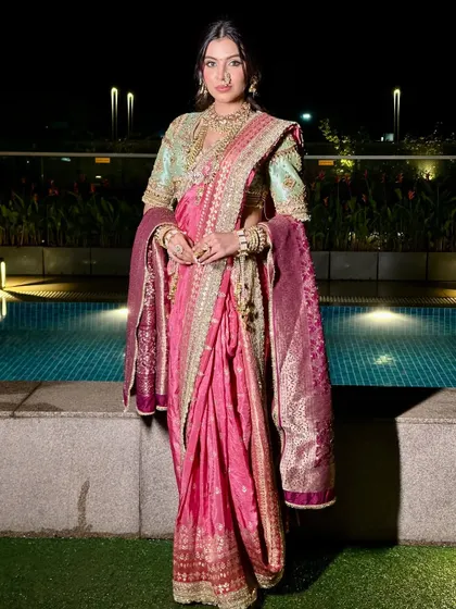 A full-length view of the royal Maharashtrian ensemble, showing how the makeup harmonizes with the entire look by the poolside.