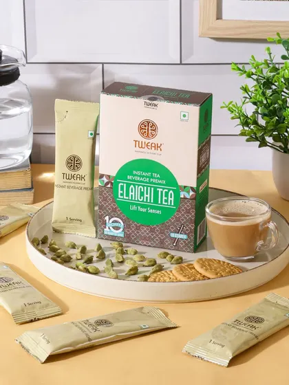 A modern and clean lifestyle setting for Elaichi Tea. This composition, featuring a glass teapot and contemporary decor, positions the instant tea as a convenient choice for a modern home.