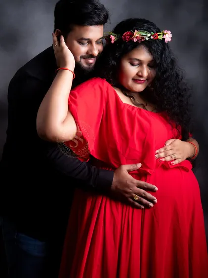A sweet couple's portrait from a studio session. The floral crown adds a bohemian touch to the mom-to-be's look.