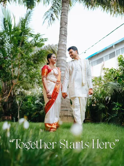 A low-angle shot of the couple walking hand-in-hand in a garden setting, creating a sense of intimacy and focusing on their connection.