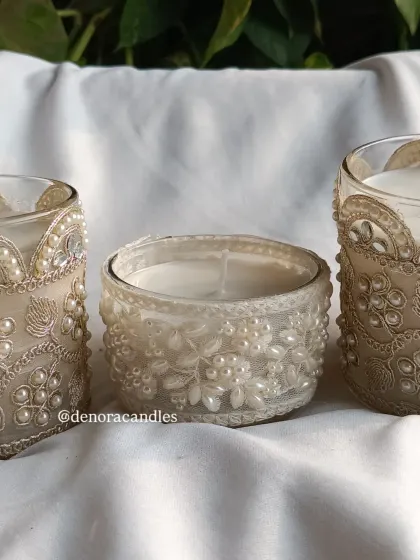 A trio of my decorative lace-wrapped jar candles, showing different designs.