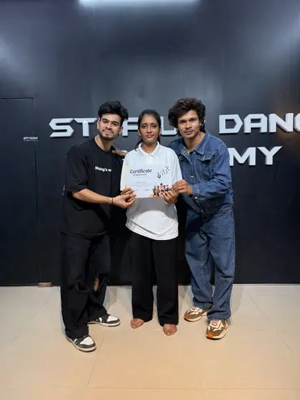 Awarding a certificate to another promising dancer from our academy. She is now prepared for professional auditions.