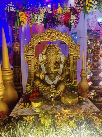 A detailed look at the beautifully decorated golden Ganesha statue. This is often placed at the entrance of a wedding to welcome guests and bestow blessings.