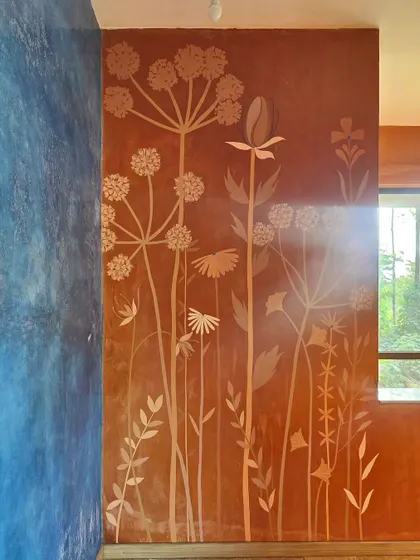 A full view of the wildflower mural. The design is light and airy, giving the impression of a field of flowers growing up the wall.