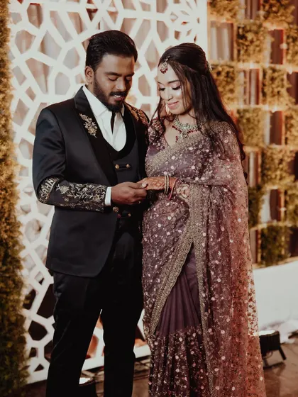 A candid moment from a reception. The bride's soft, romantic makeup and hairstyle look beautiful in the warm lighting of the event.