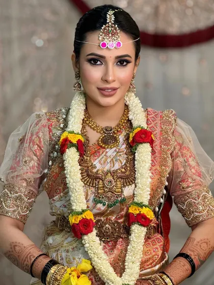 Another beautiful portrait with the flower garland, capturing the bride's happy and serene expression.