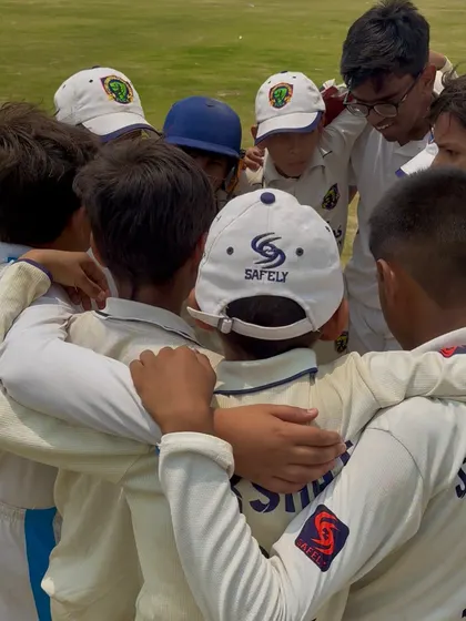 A team huddle during a tense chase in the final. Strategy and motivation are key.