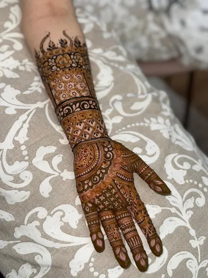 A slightly different angle of the same detailed henna design, showing the fine lines and shading.