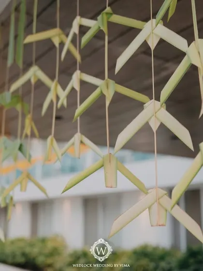 Hand-folded coconut leaves used as hanging decor for a Haldi ceremony. This sustainable and traditional craft adds a unique and rustic charm to the event.