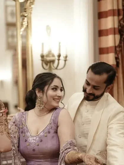 A candid shot of a couple during their mehendi ceremony, sharing a happy moment.