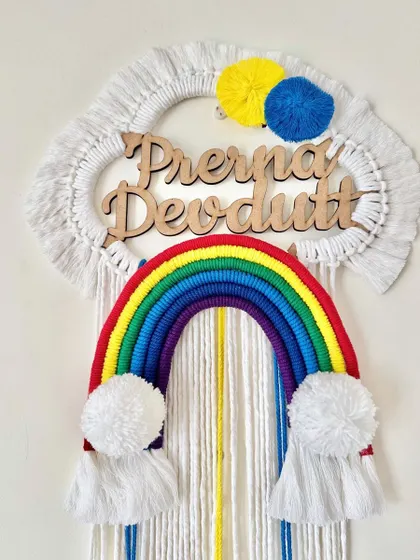 Another view of the "Prerna Devdutt" name hanging, showing the vibrant colors.