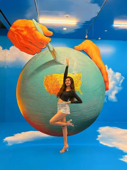 Reaching for the paintbrush. This exhibit was so interactive and visually stunning.