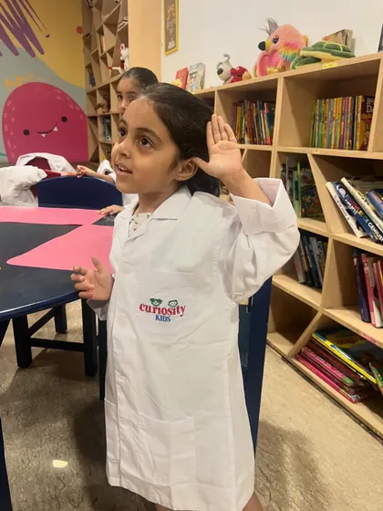 A student actively participates in a lesson about the senses. Hands-on activities help solidify complex concepts in a simple, memorable way.