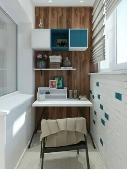 A minimalist and clean home office design for a small balcony. The simple desk and floating shelves against a wood-paneled wall create a calm and focused environment.