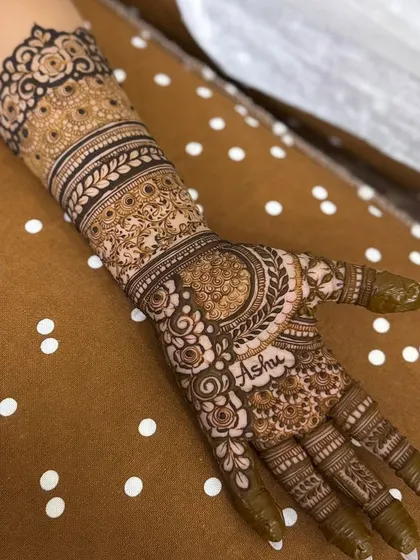 This engagement henna features a full arm of detail but with a slightly more open feel than a heavy bridal design. The personalized name makes it extra special.