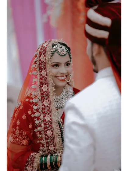 The bride's radiant smile as she looks at her groom during their Nikah ceremony.