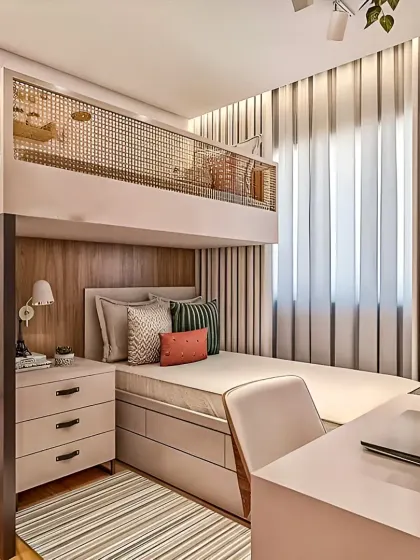 This is how we make a small bedroom work for both rest and productivity. We designed this custom loft bed with an integrated desk and storage unit below, creating a complete living solution in a minimal footprint. The light color palette and cane details keep the space feeling airy and open.