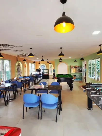 A wide shot of the entire cafe, including the gaming area, showing how our artwork enhances the light and airy atmosphere.