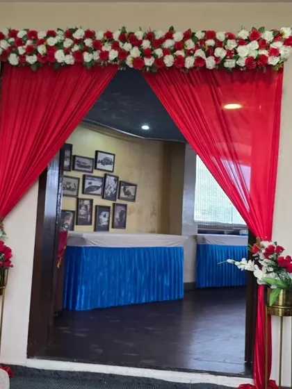 A closer view of the elegant red and white entrance decor for a baby shower.