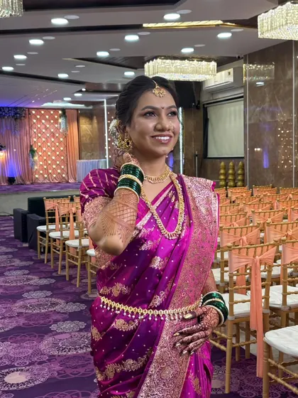 A full-length shot of the bride, looking radiant and graceful. The makeup enhances her natural beauty without overpowering her traditional attire.