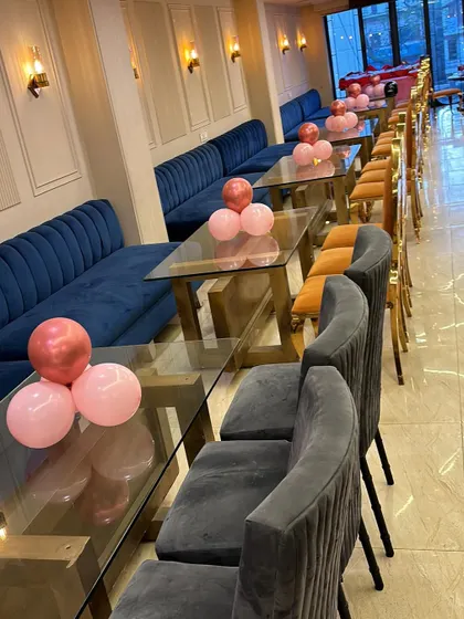 A simple yet elegant setup for an anniversary celebration in a restaurant. I placed small clusters of pink and rose gold balloons on the tables to add a festive touch without cluttering the space.