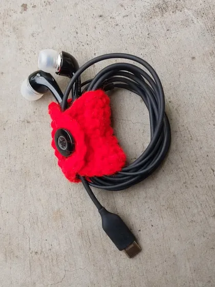 Tired of tangled earphones? This little crochet bell-shaped holder snaps shut to keep your cables neat and tidy.