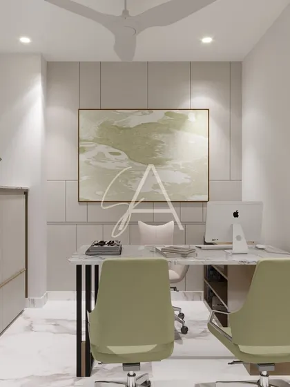 A front view of a private office, where a paneled wall adds texture behind the desk. The subtle green tones in the chairs and artwork create a calm and focused atmosphere.