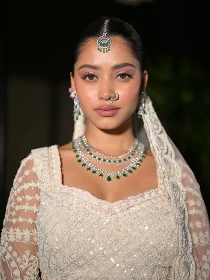 A confident and direct portrait. The makeup is subtle yet impactful, enhancing her beautiful features.