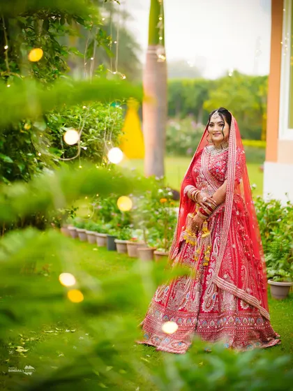 A beautiful bridal portrait in a garden setting. The soft, natural light and the lush greenery create a serene and picturesque backdrop.