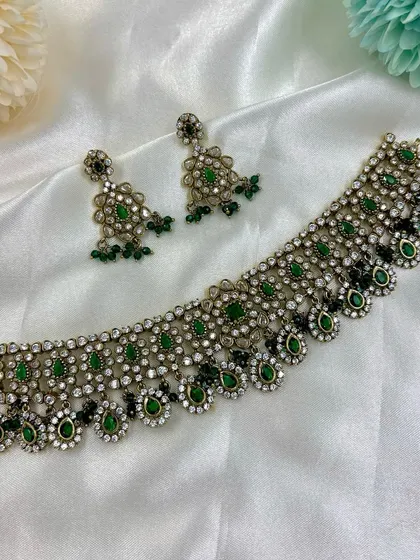 A beautiful choker set with a delicate design, shown in multiple pastel colors including grey, pink, and mint green.